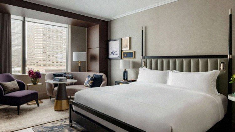 King room with sitting area and skyline view at Raffles Boston