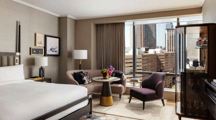 Suite seating area with city view at Raffles Boston