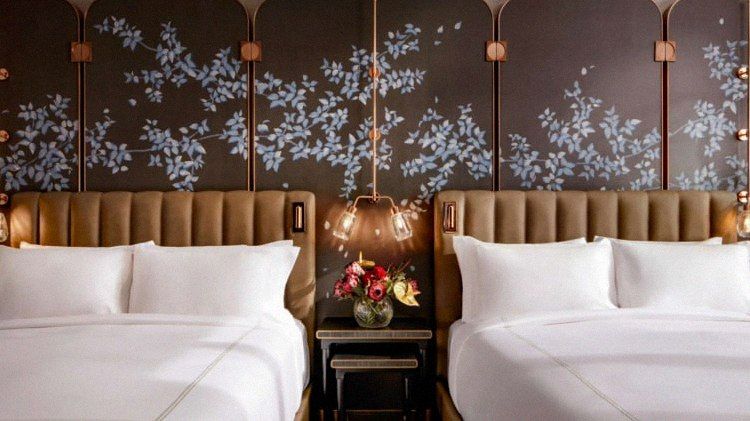 Twin guest room with hand-painted floral wall mural at Raffles Boston